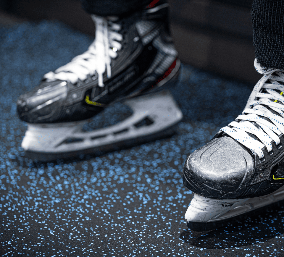 Hockey skates on rubber flooring
